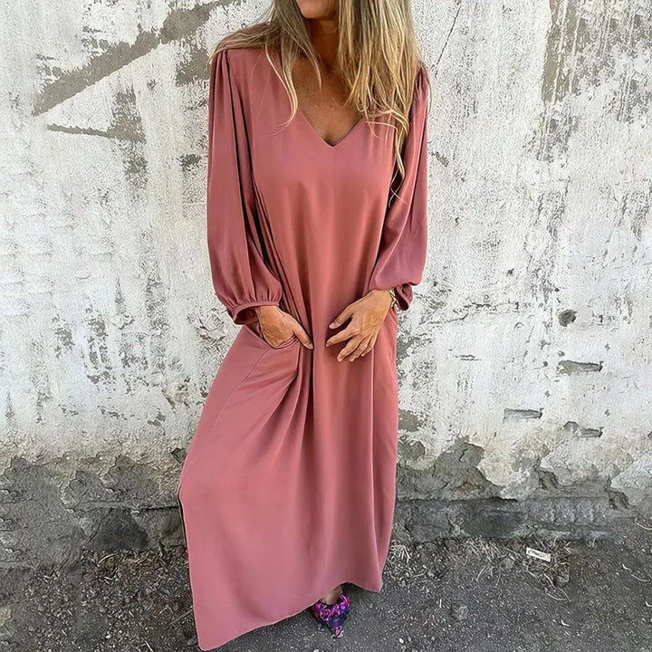 Bohemian style flowing maxi dress for women, featuring a flattering V-neck, bishop sleeves, and comfy pockets.