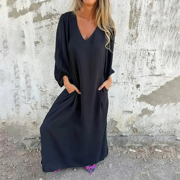 Women's V-neck maxi dress with stylish bishop sleeves & pockets. Flowing fabric for comfort & elegance.