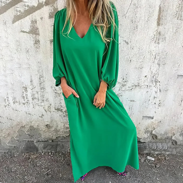Graceful women's flowing maxi dress with V-neck, bishop sleeves, & discreet pockets, perfect for any occasion.
