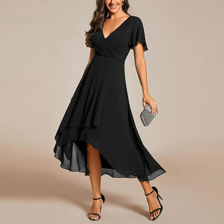 Comfortable women's flowing midi dress, soft fabric, V-neck, flutter sleeves, versatile for day or evening wear.