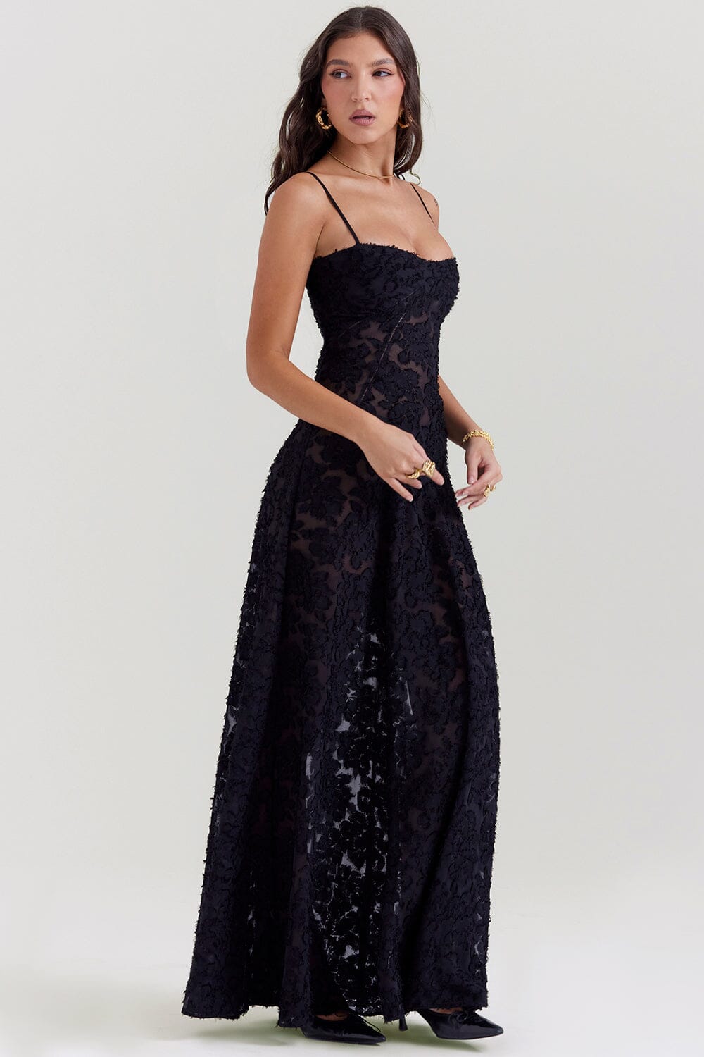 Back view of a women's elegant flowy maxi dress, showcasing its graceful drape for formal or party wear.