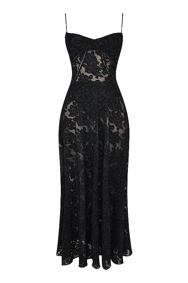 Woman in elegant flowy maxi dress walking outdoors, perfect for summer events & chic formal occasions.