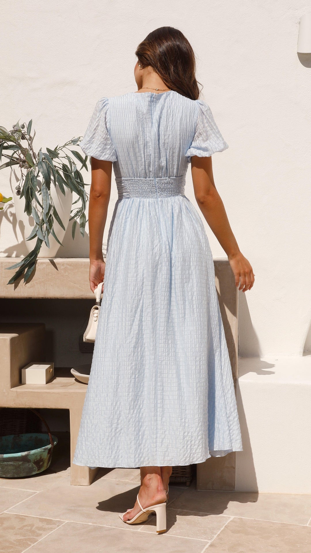 Close-up of the elegant button-front detail on a women's long flowy maxi dress, showcasing quality.