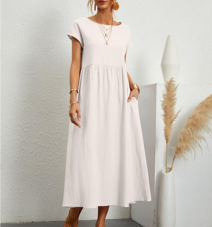 Woman wearing a comfortable, elegant flowy maxi summer dress. Breathable & perfect for casual outings.