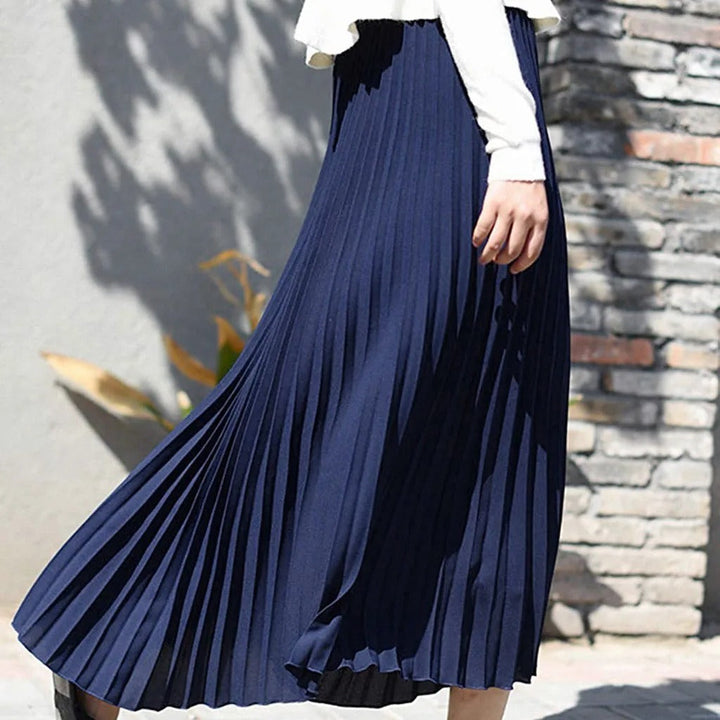 Elegant women's flowy pleated midi skirt. Versatile all-season fashion for a chic look.