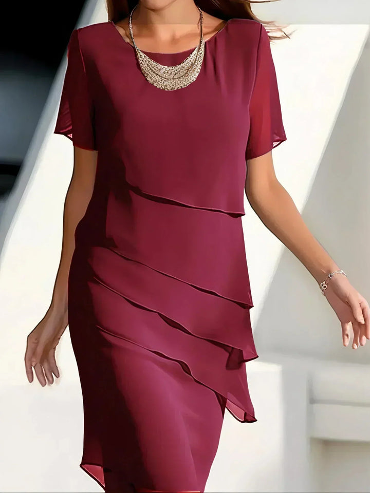 Chic women's flowy short sleeve dress, a versatile piece for casual comfort or an elegant summer event.