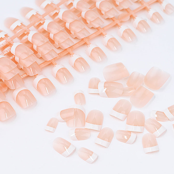 Sophisticated French tip press-on nails for women. Achieve an elegant nail art look with these quick fake nails.
