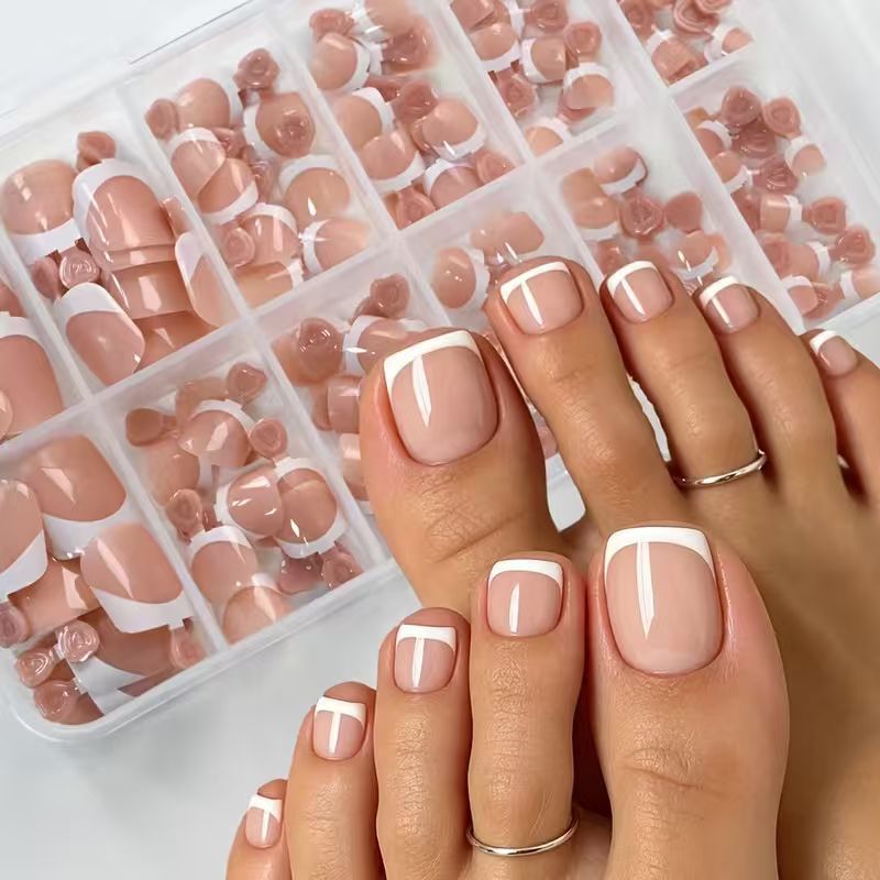 Complete women's French tip press-on toenail set. Achieve an elegant, instant pedicure with false nails.