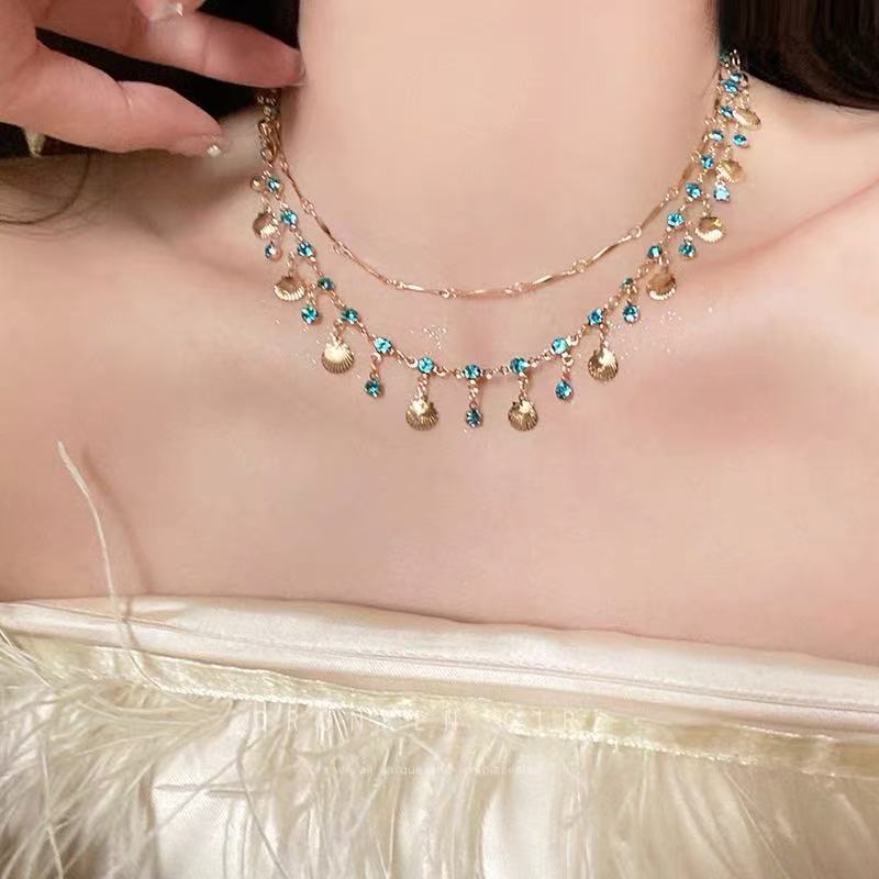 Versatile women's elegant gemstone necklace, delicate design with a shimmering shell color stone.