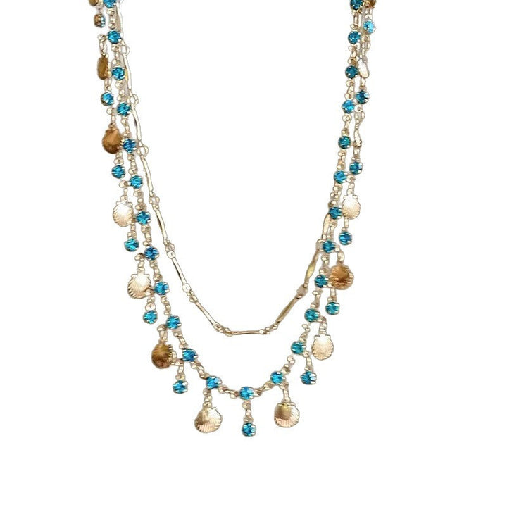 Close-up of the delicate shell color gemstone pendant on an elegant women's adjustable necklace.