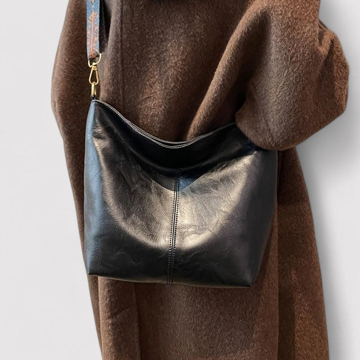 Spacious women's leather tote bag, versatile for daily essentials or travel.
