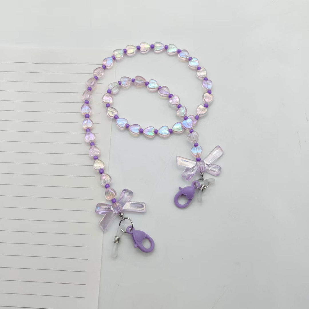 Fashionable women's glasses chain, adorned with pretty heart & flower charms. A lovely gift idea and practical eyewear holder.