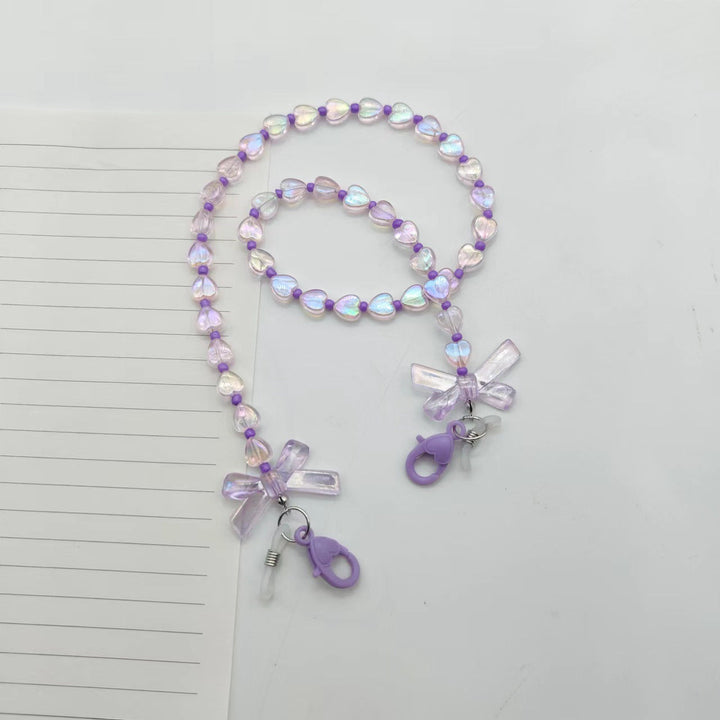 Fashionable women's glasses chain, adorned with pretty heart & flower charms. A lovely gift idea and practical eyewear holder.