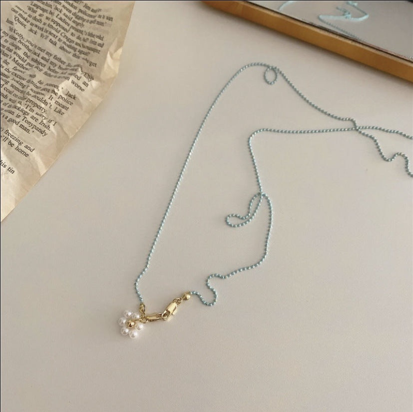 Elegant women's glasses chain with lustrous white pearls and delicate gold accents, a stylish eyewear holder.