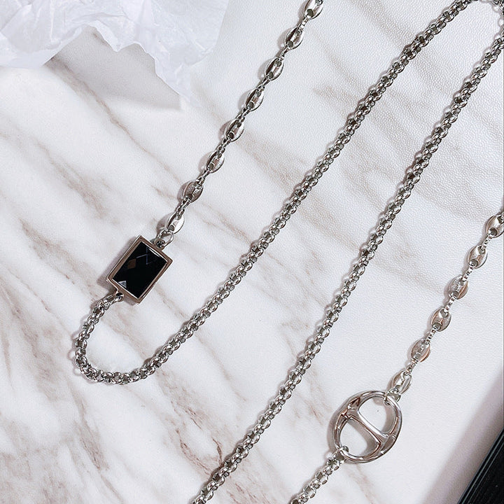 Chic stainless steel eyewear chain for women, featuring a modern rectangular pendant. Stylish glasses holder necklace.