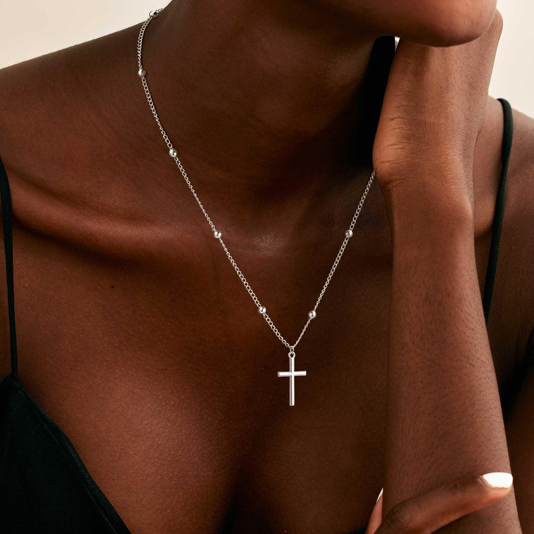 Delicate gold cross pendant necklace for women, perfect elegant gift for religious jewelry lovers.