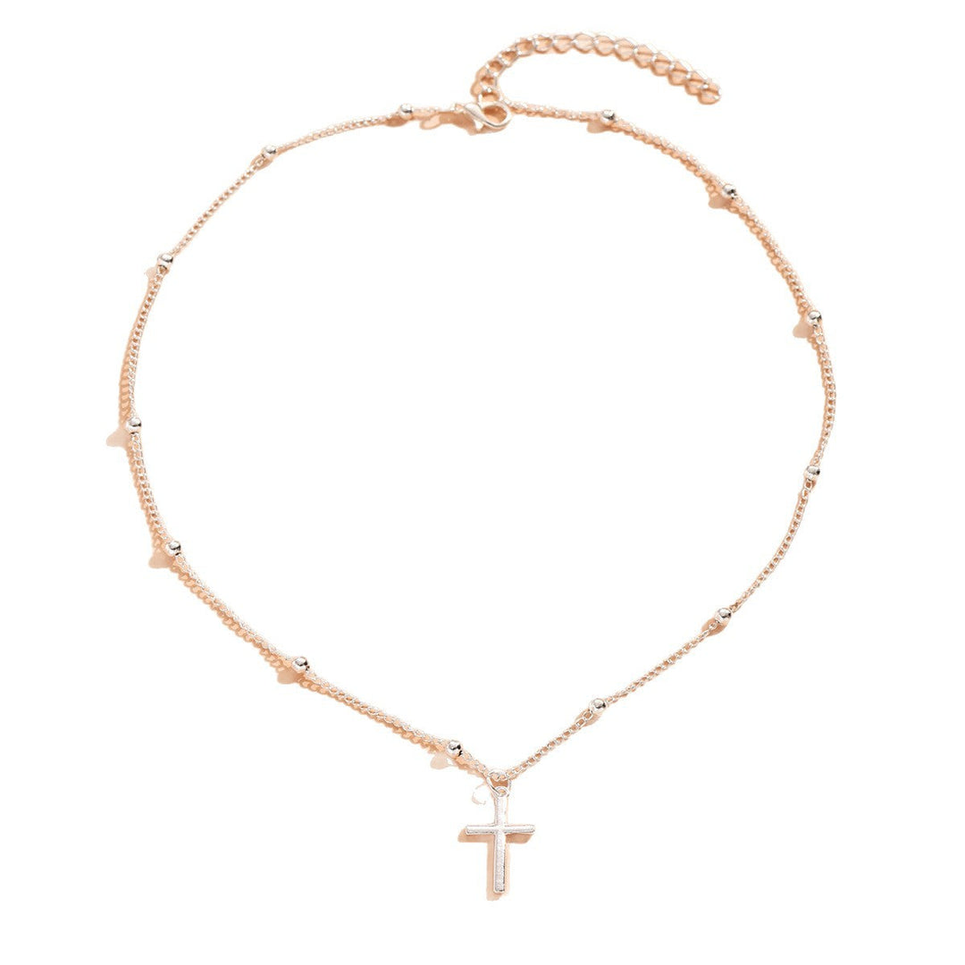 Shimmering gold cross pendant necklace, an elegant and spiritual accessory for women's daily wear or special occasions.