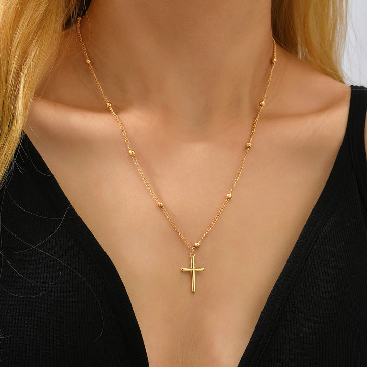 Beautiful gold cross pendant necklace with a fine chain, a spiritual and elegant women's religious accessory.
