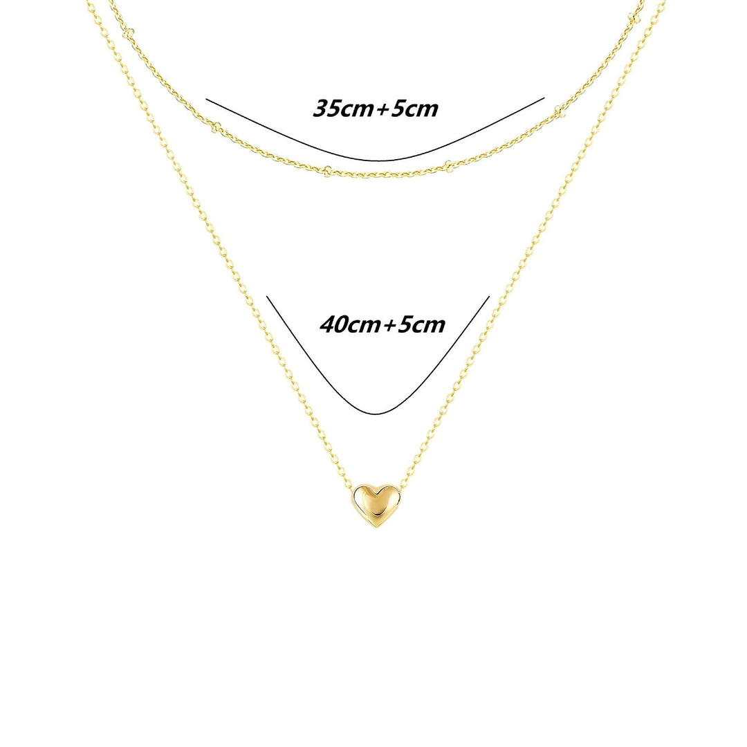 Fashionable gold layered necklace with a dainty heart pendant, an elegant and chic women's jewelry piece.