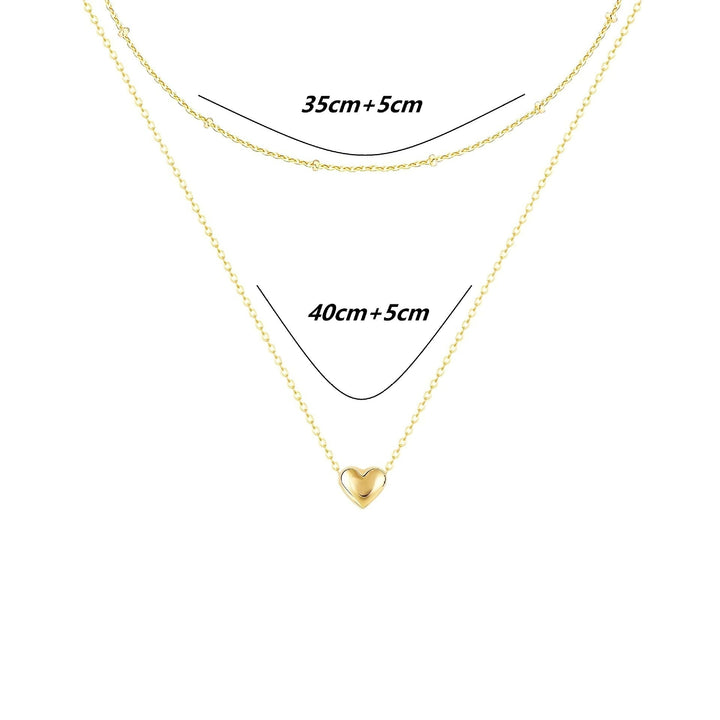 Fashionable gold layered necklace with a dainty heart pendant, an elegant and chic women's jewelry piece.