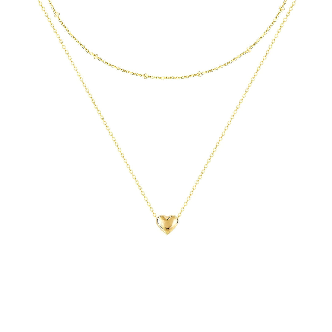 Beautiful women's gold layered necklace with an elegant heart pendant, a chic jewelry gift always in fashion.