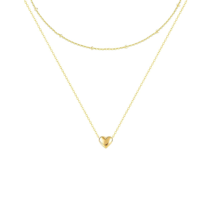 Beautiful women's gold layered necklace with an elegant heart pendant, a chic jewelry gift always in fashion.