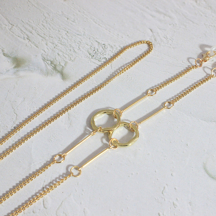 Chic women's gold necklace featuring unique geometric patterns, a luxurious accessory for modern women.