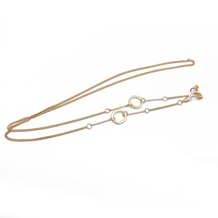 Detailed women's gold necklace with striking geometric design, an elegant and modern piece of fine jewelry.