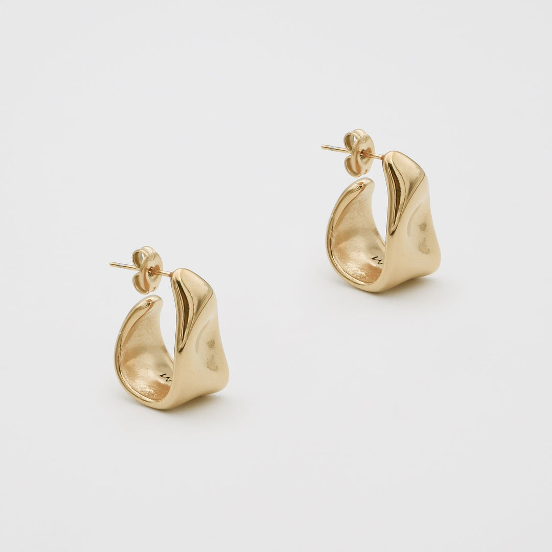 Modern women's silver textured half hoop earrings, versatile for daily or elegant wear.