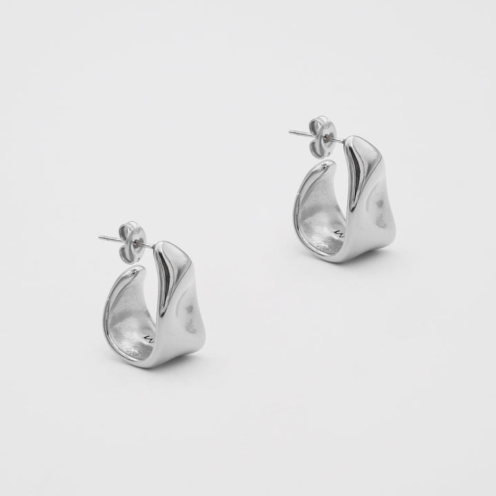 Fashionable women's textured half hoop earrings, available in gold and silver tones.