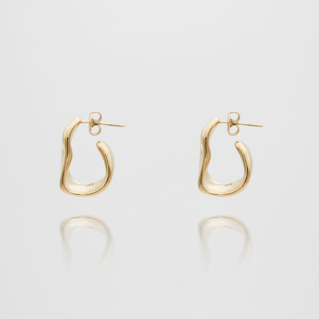 Contemporary women's silver textured half hoop earrings, ideal for elevating any outfit.