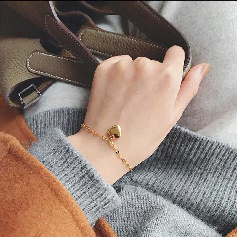 Dainty gold heart charm bracelet for women, a romantic & elegant adjustable fashion accessory. Perfect gift.