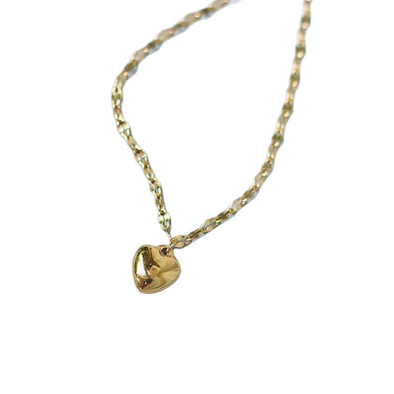 Gold tone heart charm bracelet for women, featuring a dainty design and adjustable fit. Romantic jewelry.