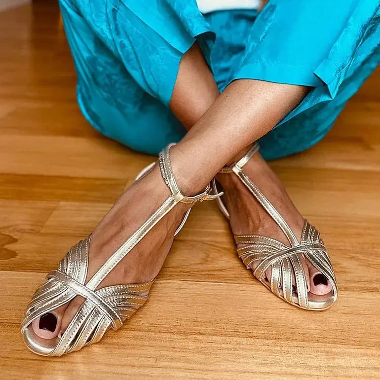 Elegant women's gray metallic T-strap flat sandals for evening wear, perfect for parties and summer events.