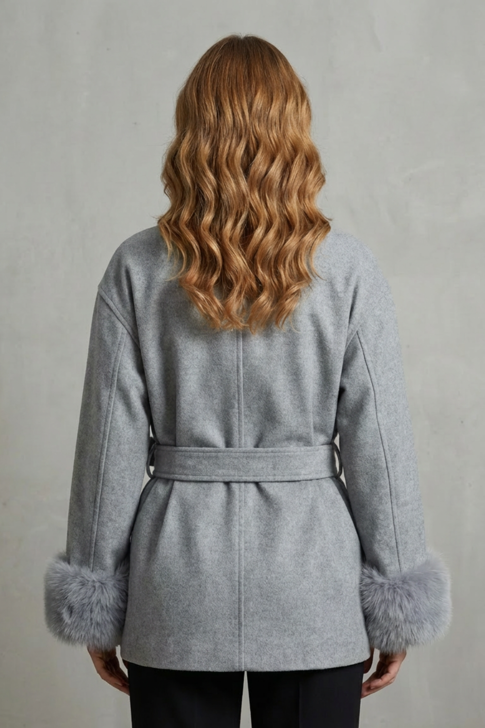 Stylish grey women's wrap coat with a cozy faux fur collar and cinching belt, ideal for elegant winter apparel.