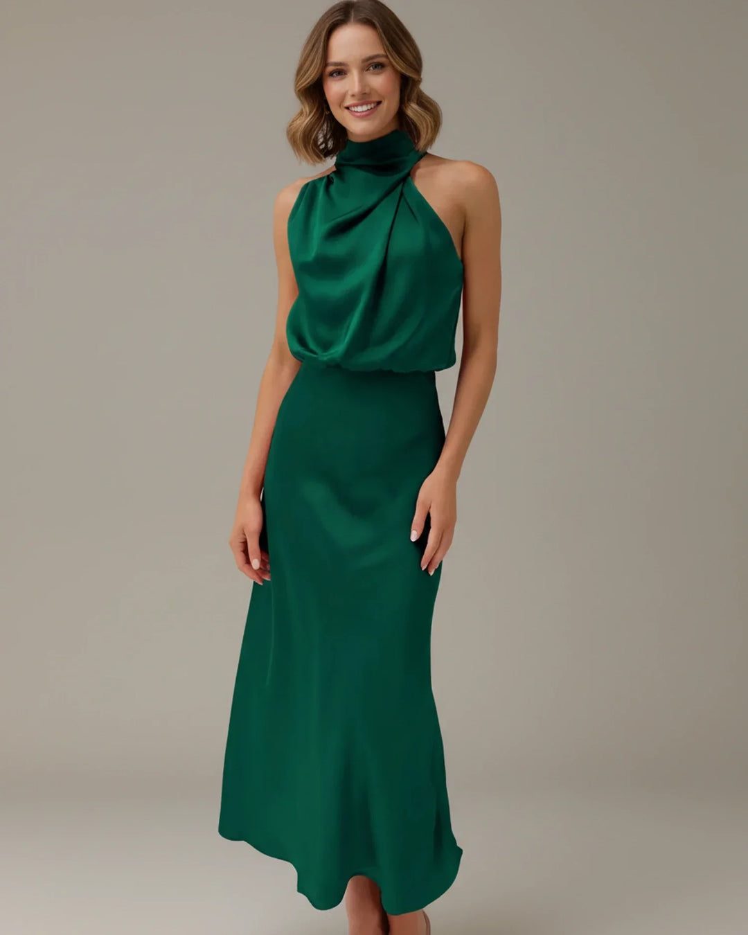 Women's elegant party midi dress, featuring a sophisticated halter neck and luxurious cowl drape.