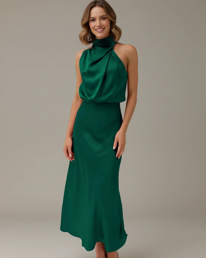 Women's elegant party midi dress, featuring a sophisticated halter neck and luxurious cowl drape.