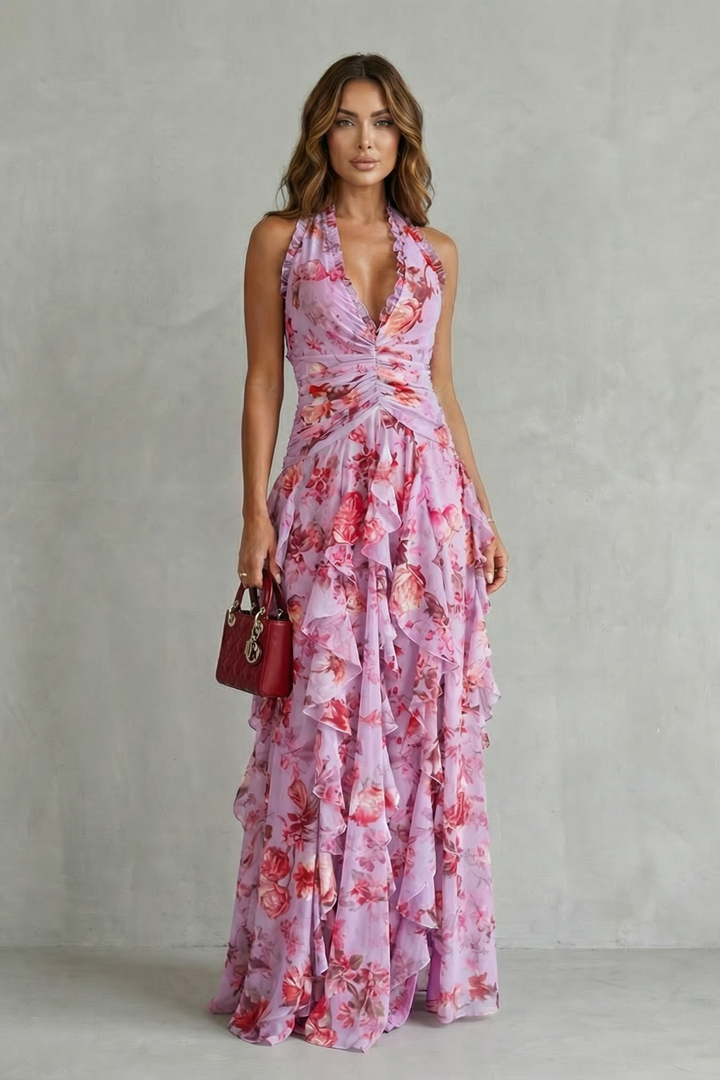 Close-up of a women's elegant halter maxi dress, showcasing its romantic floral pattern and flowing fabric.