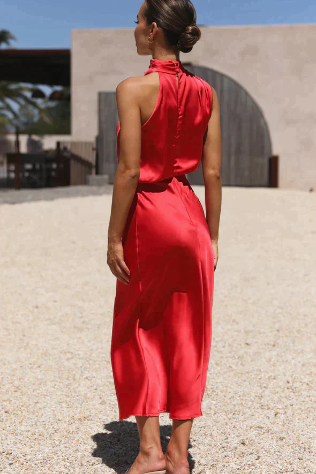 Women's fluid silhouette halter neck midi dress, perfect for a wedding guest or cocktail party.