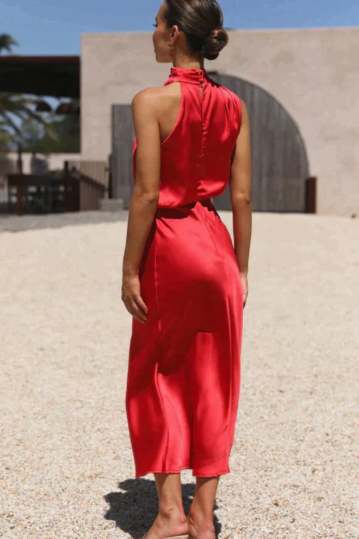 Women's fluid silhouette halter neck midi dress, perfect for a wedding guest or cocktail party.