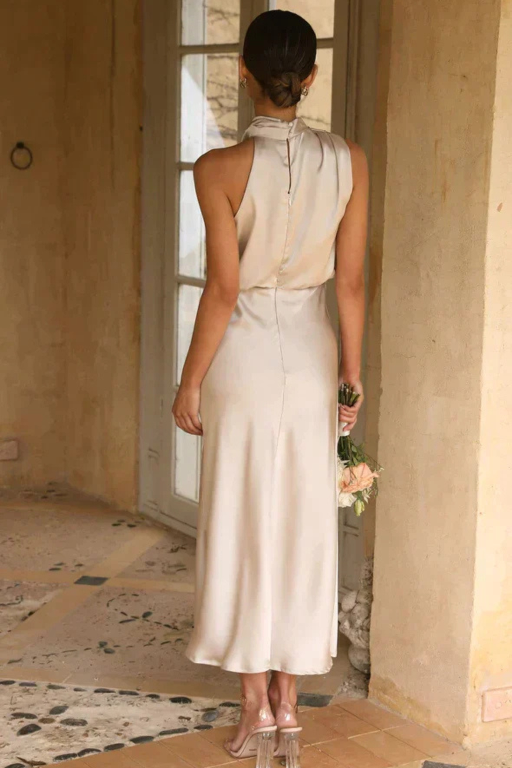 Fluid silhouette women's midi dress with a stylish halter neck, perfect for formal events.