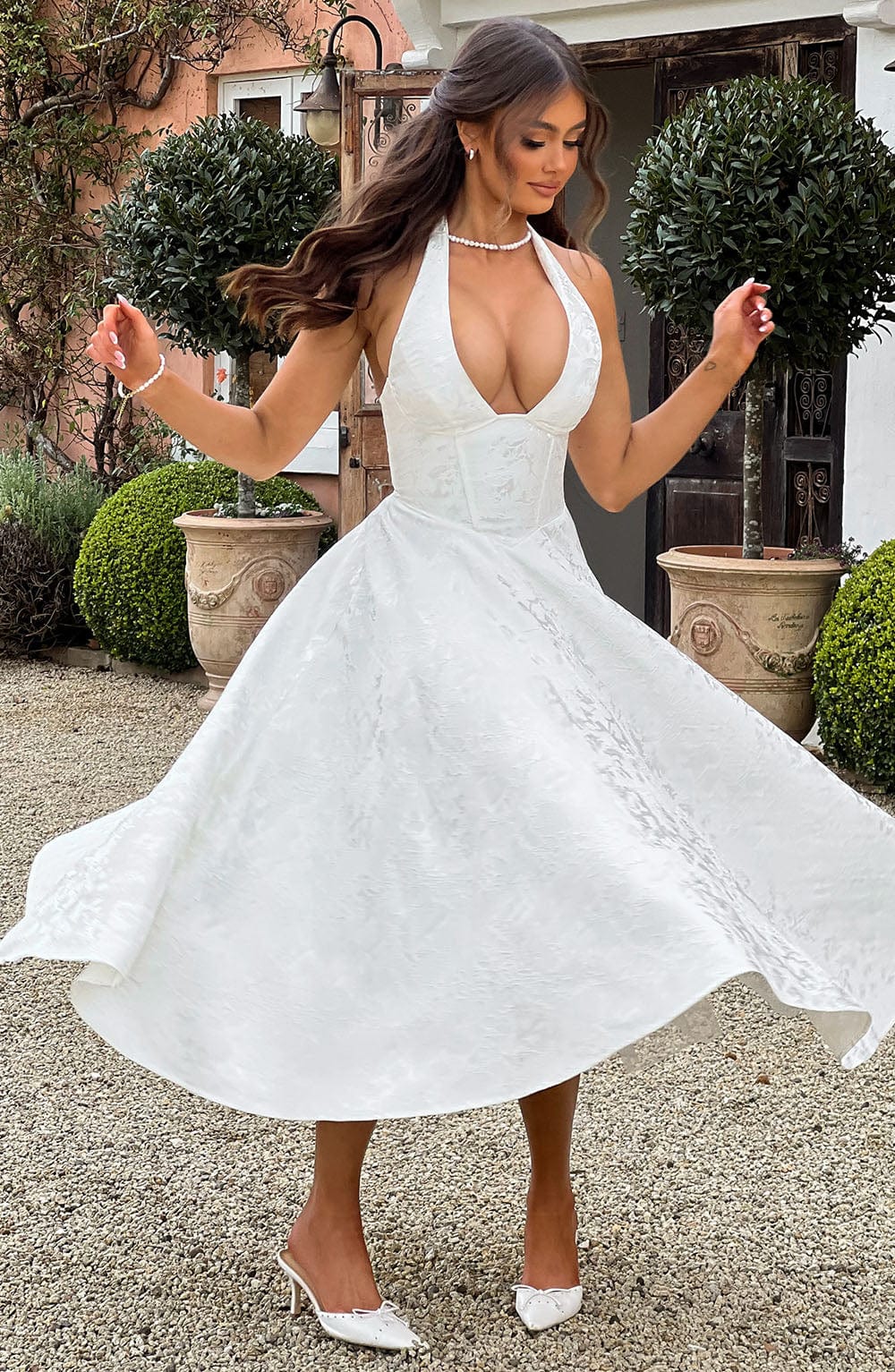 Party-ready women's halter midi dress, an elegant option for wedding guests and celebrations.