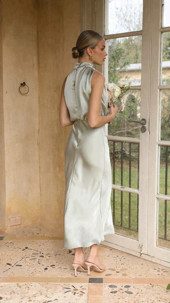 Luxurious women's elegant halter midi dress with a flowing draped neckline, great for summer parties.