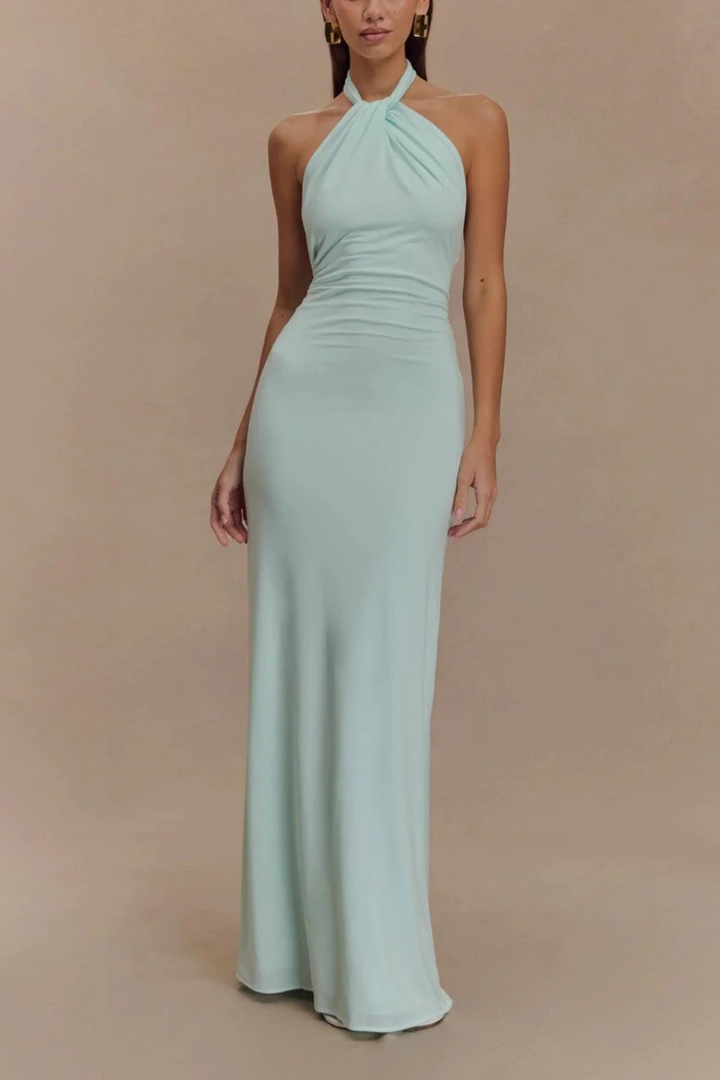 Chic women's wedding guest maxi dress. Halter neck, bodycon fit, open back & elegant twisted knot detail.