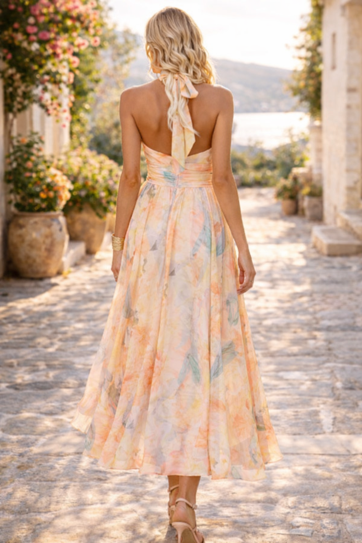 Stylish sleeveless women's floral print halter neck maxi dress. Features a beautiful pleated skirt; perfect party wear.