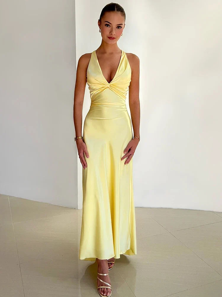Glamorous sleeveless satin maxi dress for women, featuring a chic halter neckline & flowing silhouette.