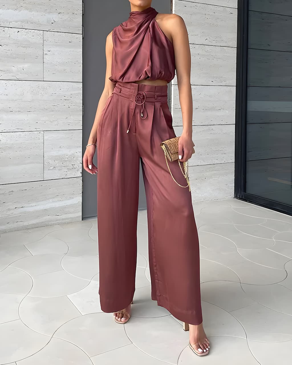 Women's versatile two-piece outfit: elegant halter neck top & high-waist trouser set. Chic for summer occasions.