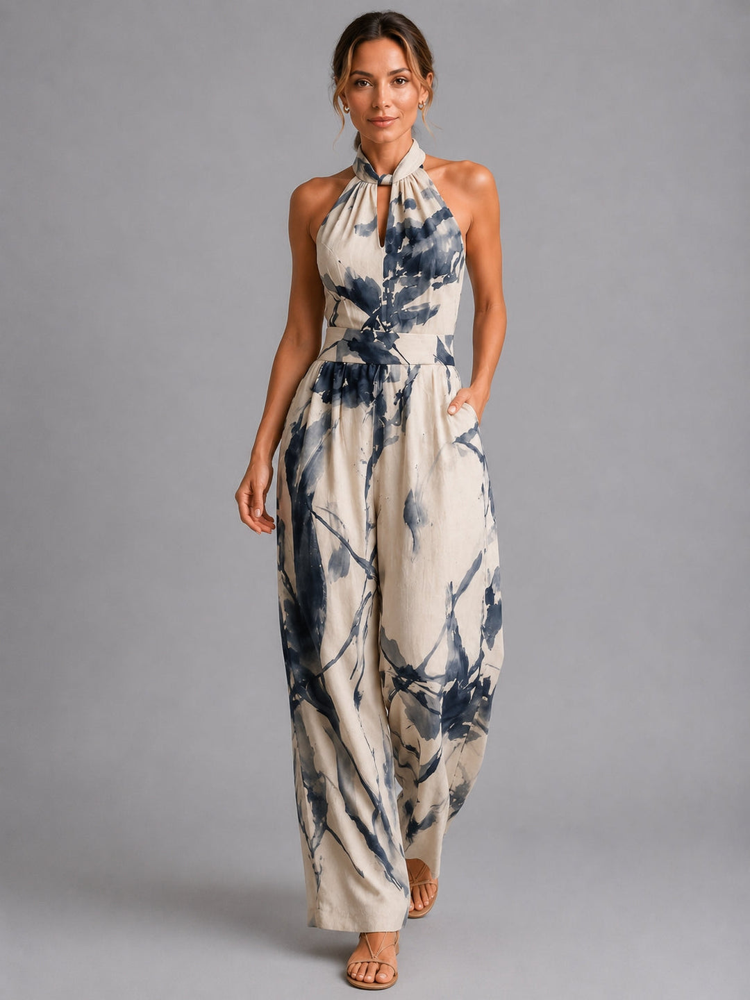 Elegant women's halter neck wide-leg jumpsuit with a stylish print, perfect for summer vacations & casual chic.