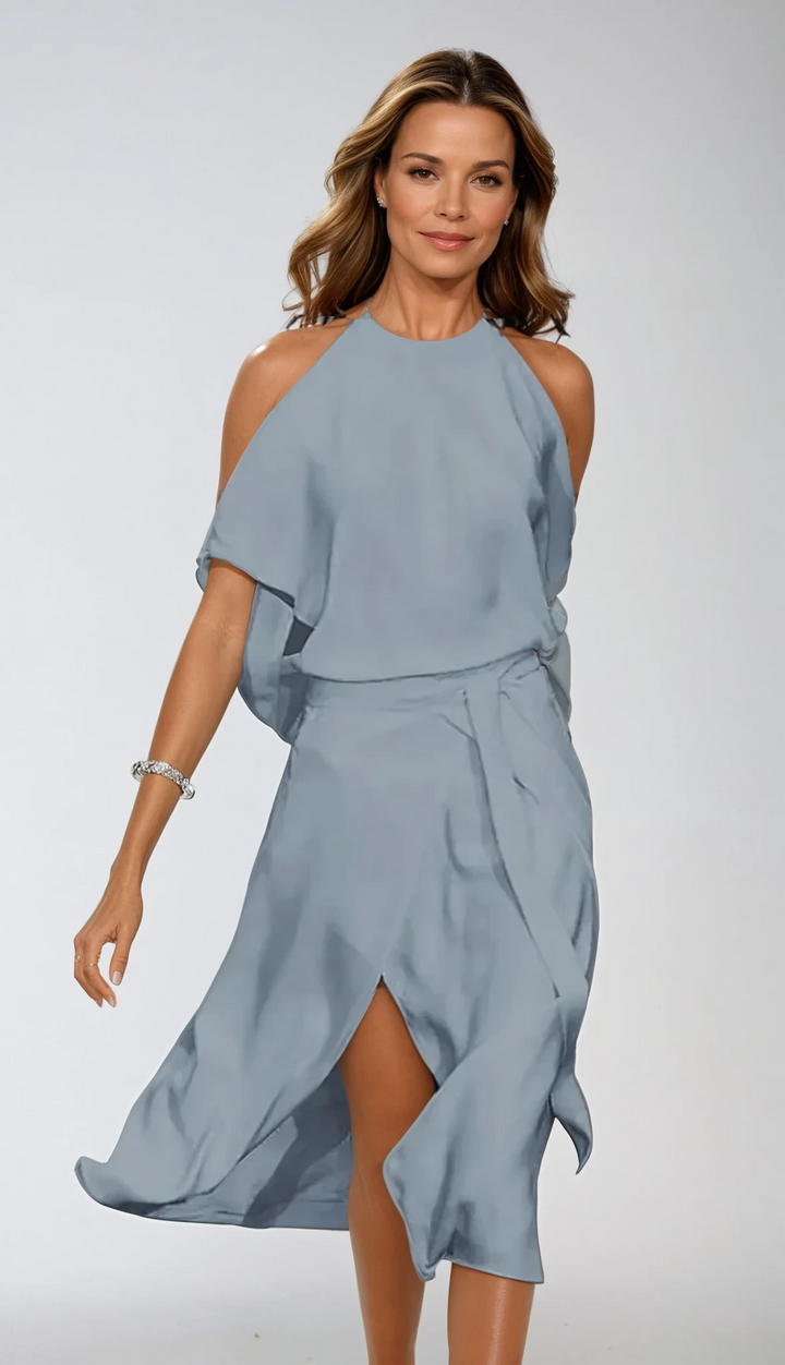 Flowing women's midi dress with halter neck and flattering wrap design. Ideal for elegant parties and events.