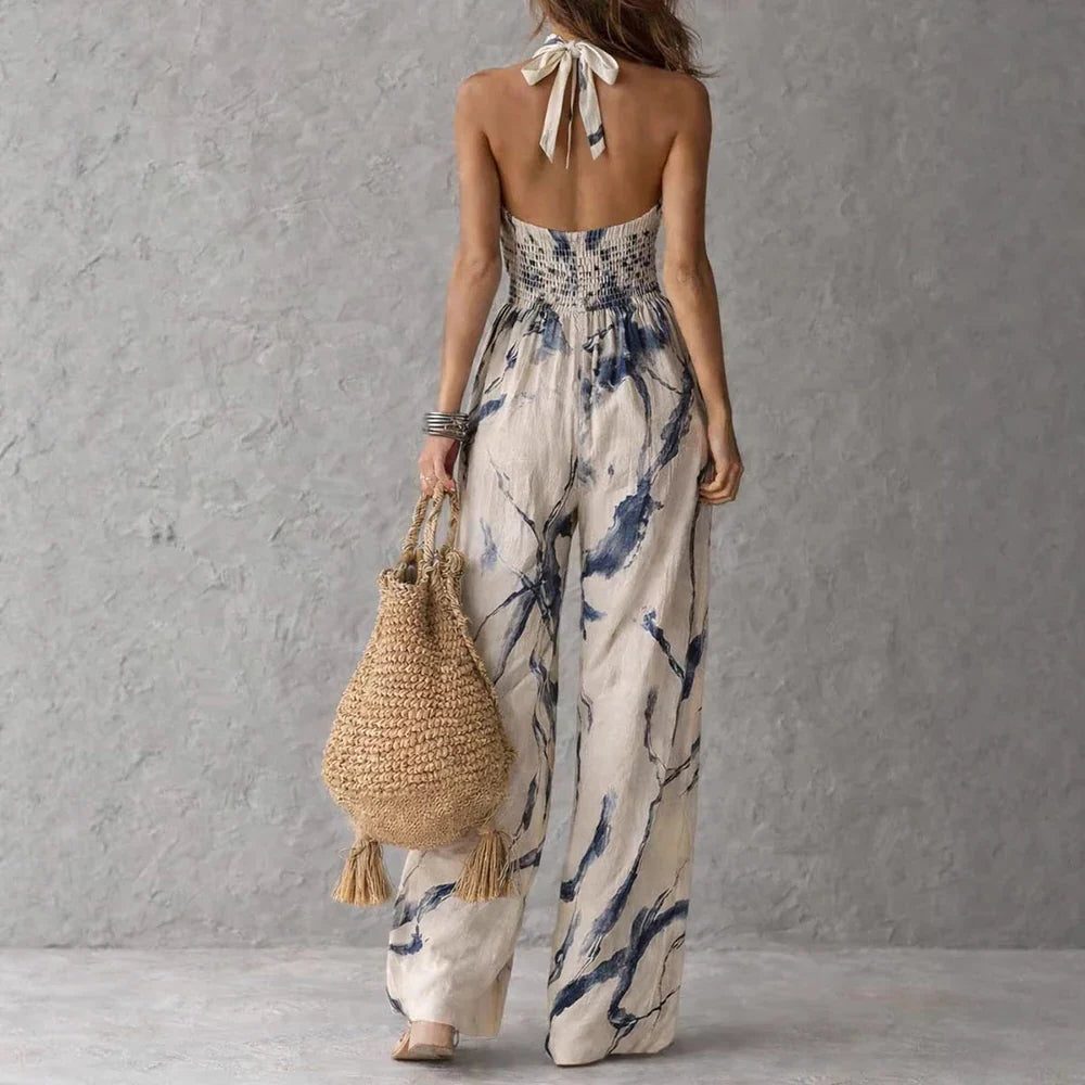 Modern women's wide leg jumpsuit with halterneck. Elegant, relaxed fit for summer chic.
